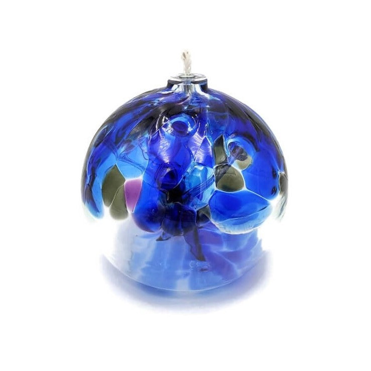 Blown clear glass with deep cobalt blue and accents of purple, and dark green.  Features a wick for use as an oil lamp.